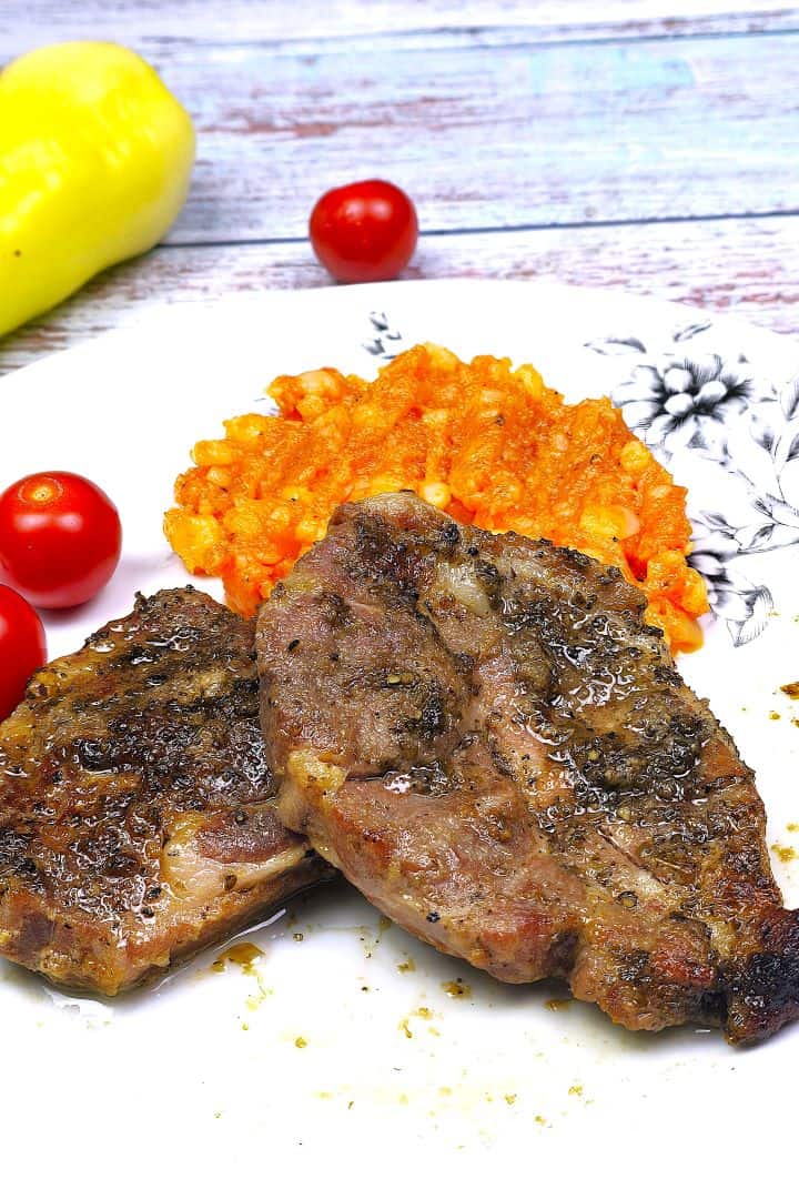 Juicy Oven-Baked Pork Steak Served on Plate With Potatoes