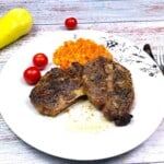 Oven-Baked Pork Steak Served on White Plate With Mashed Potatoes