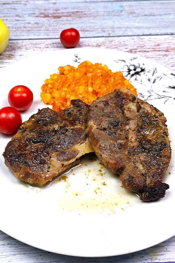 Oven-Baked Pork Steak Served on White Plate With Mashed Potatoes