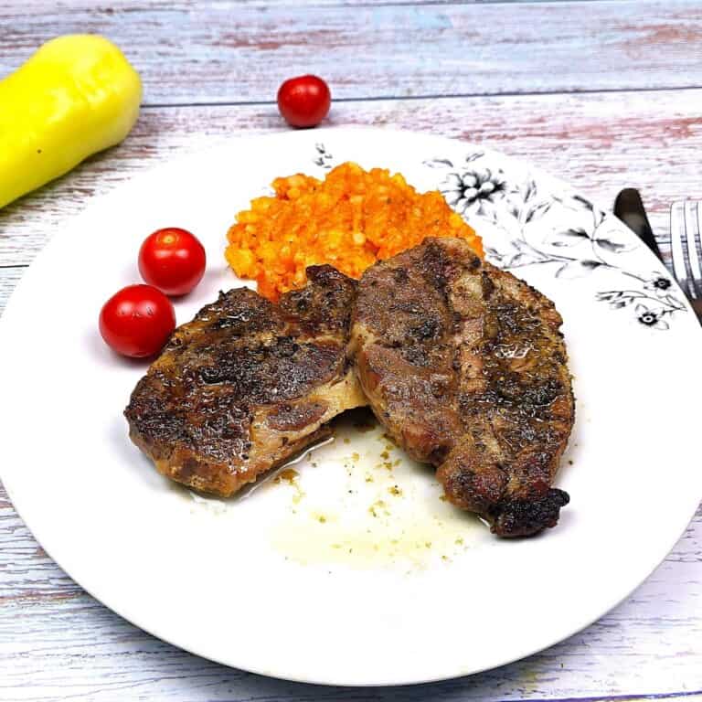 Oven-Baked Pork Steak Served on White Plate With Mashed Potatoes