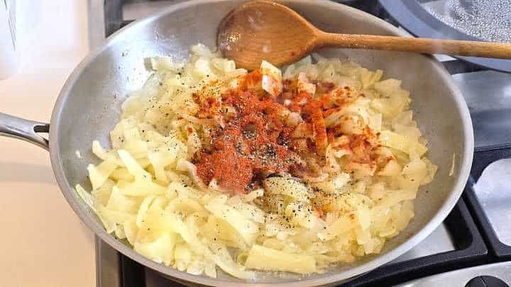Onions and yellow wax peppers coated in vibrant red sweet Hungarian paprika.