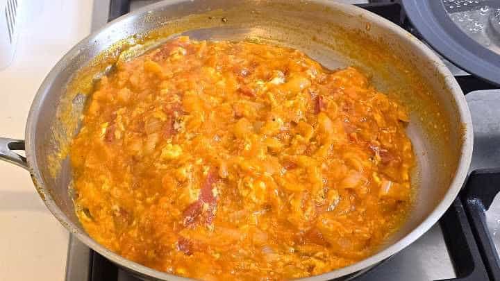 Finished Hungarian vegetable stew with silky marbled eggs ready to serve in the pan.