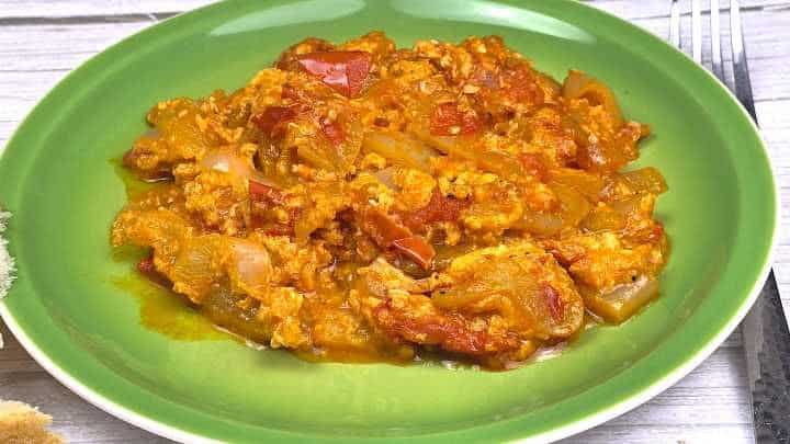 Close-up view showing the silky texture of Tojásos Lecsó with tender wax peppers and tomatoes.