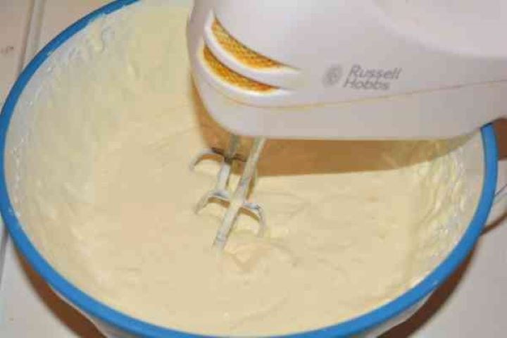 Noodle Kugel With Raisins-Mixing the Cheese Cream With Ingredients in the Bowl Mixing the Cheese Cream With Ingredients in the Bowl