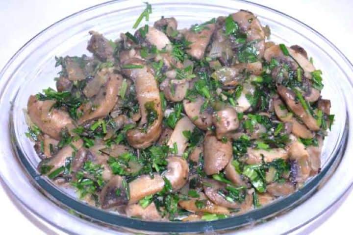 Ready Stirring half of the chopped fresh parsley and chives into warm sautéed garlic mushrooms.