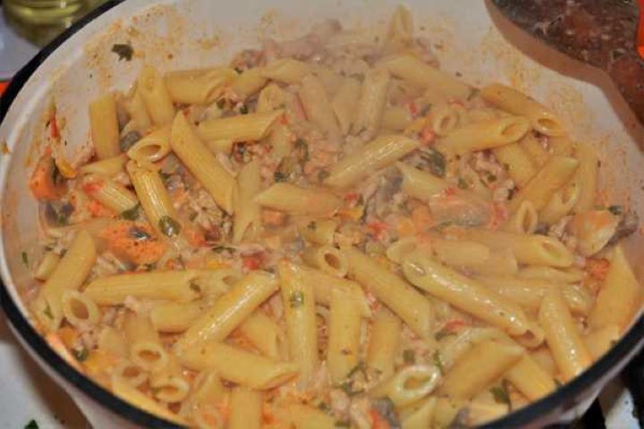 Skillet of creamy pork mince pasta with mushrooms and penne ready to serve.