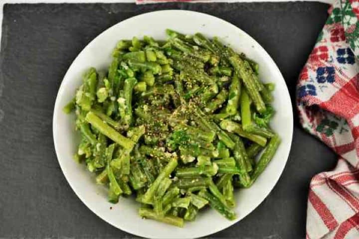 Green Bean Salad With Garlic Cream-Served in Bowl With Ground Pepper on Top Rustic Transylvanian green bean salad with garlic cream served in a ceramic bowl