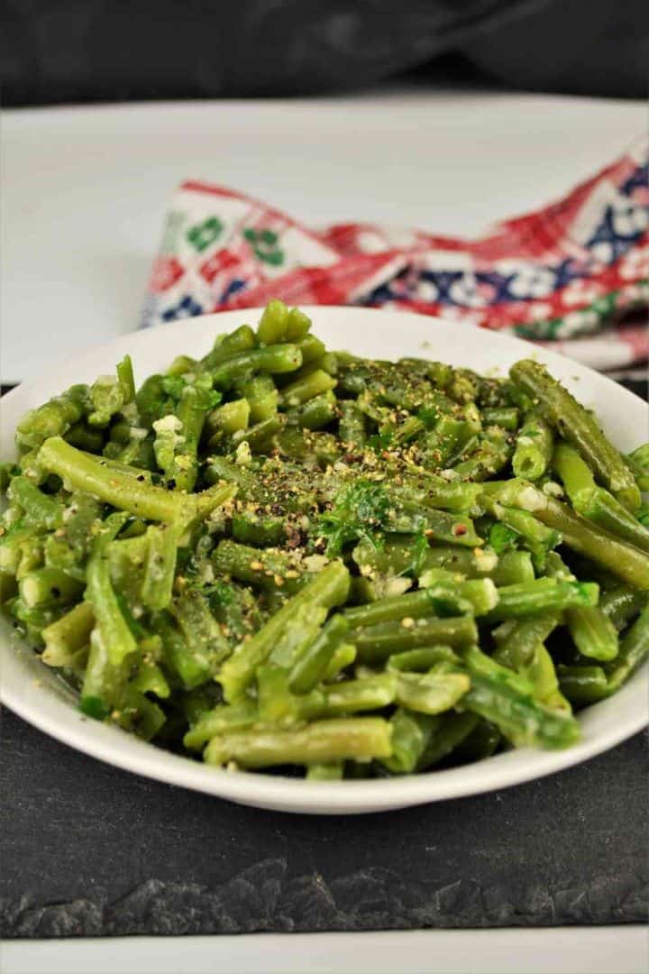 Transylvanian Green Bean Salad With Garlic Served in Bowl With Ground Pepper on Top