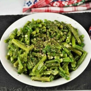 Rustic Transylvanian green bean salad with garlic cream served in a ceramic bowl