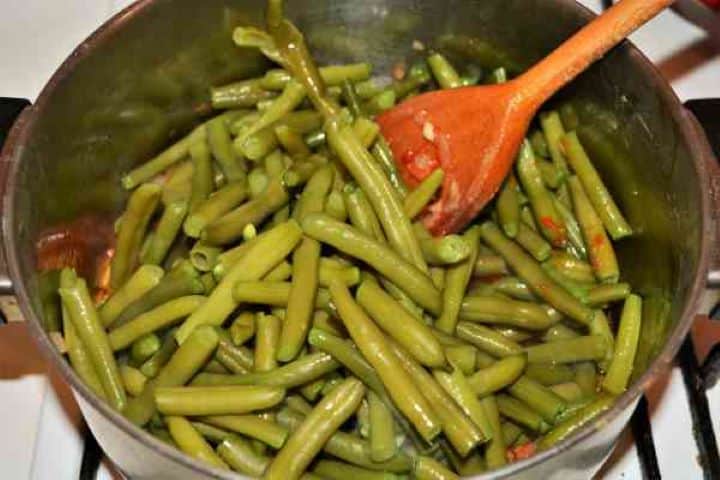 Boiled Beans on Onion Adding boiled green beans to sautéed onion and tomato paste base.