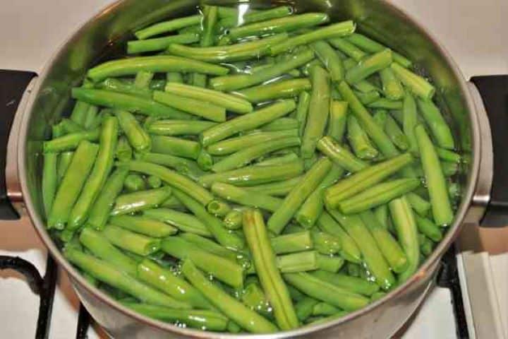 Boiling Green Beans Boiling fresh green beans in salted water in a stainless steel pot.