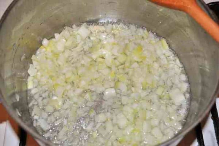Frying Chopped Onion Sautéing diced onions in extra virgin olive oil in a saucepan.