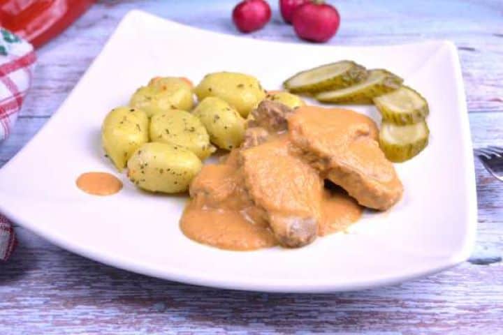 Serve Tender beef slices smothered in creamy golden vadas hunter's sauce, served alongside Italian gnocchi and pickled cucumbers.