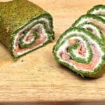 Spinach and Smoked Salmon Roulade Slices Served On Chopping Board