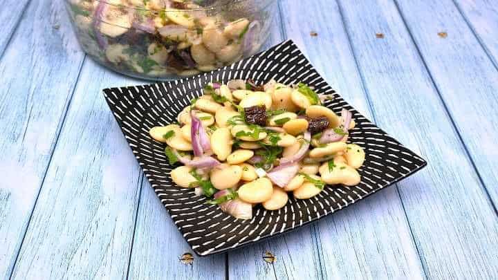 Butter Beans Salad Recipe-Serving in Bowl With Fresh Bread Butter Bean Salad Served on a Black Plate