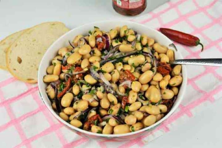Butter Beans Salad Recipe-Serving in Bowl With Fresh Bread Butter bean salad served in a bowl alongside a slice of crusty bread