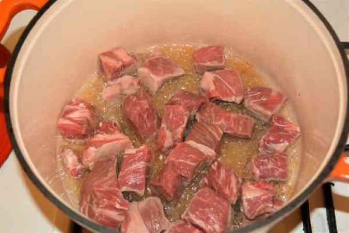 Dutch Oven Beef Stew-Frying Beef Cubes in the Dutch Oven Searing uniform beef cubes in melted pork lard to build a rich copper crust inside a cast iron Dutch oven.