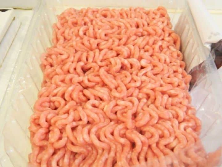 Raw ground pork and beef minced meat in a plastic tray.