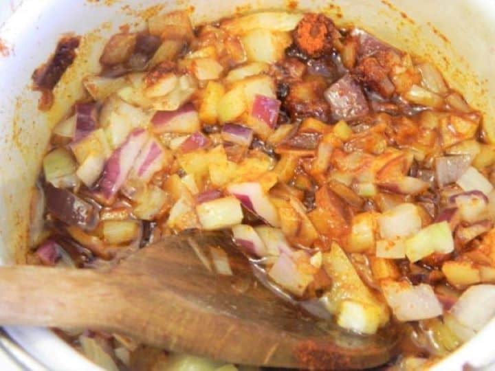 Sautéed chopped onions seasoned with sweet Hungarian paprika, sea salt, and black pepper in a pan.