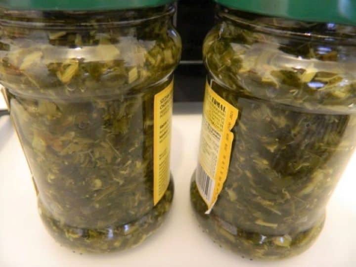 Two glass jars of traditional chopped salted sorrel used for the savory Transylvanian broth.