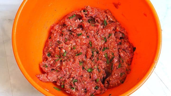 Fully combined meatball mixture with milk, spices, and beef mince ready to be shaped.
