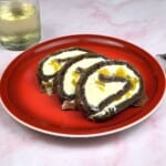 Tiramisu Cake Roll Slices Served on Red Plate