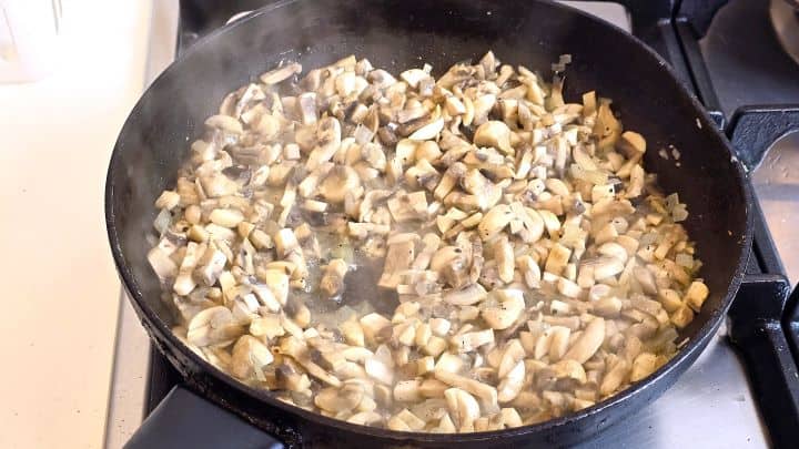 Frying Chopped Onion and Mushrooms in the Pan