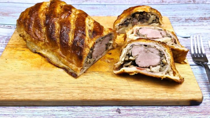 Three Pork Wellington Slices Served on Cutting Board