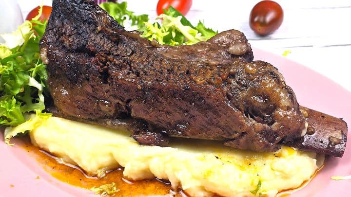 Oven Baked Short Ribs Served on Pink Plate With Mashed Potato