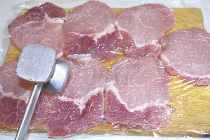 Tenderizing the Pork Chops on the Chopping Board