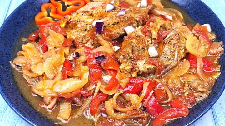 Hungarian Pork Pepper Stew Served on Plate With Red Onion on Top