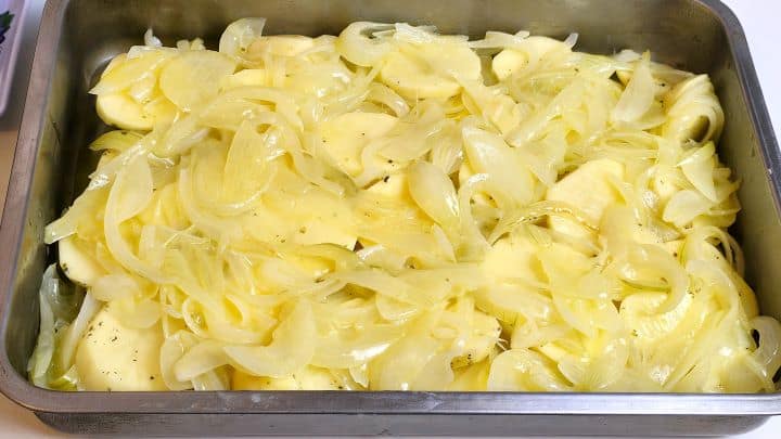 Sauteed Onions Over the Sliced and Seasoned Potatoes in the Oven Tray