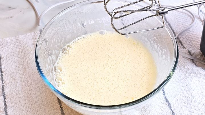 Mixed Eggs and Sugar in a Glass Bowl