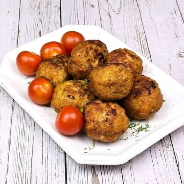 Hungarian Fried Meatballs Served on Plate With Tomatoes