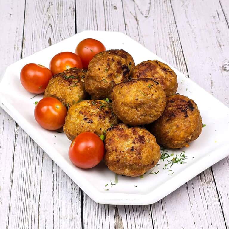 Hungarian Fried Meatballs Served on Plate With Tomatoes