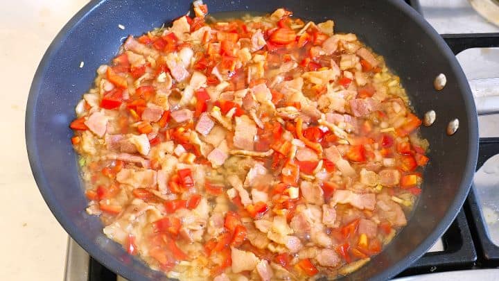 Frying Red Pepper, Onion and Cut Smoked Bacon in the Pan