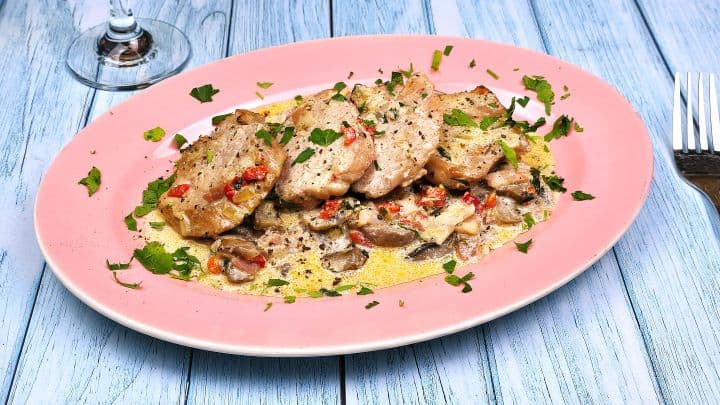 Pork Tenderloin in Creamy Mushroom Sauce Served on Oval Pink Plate