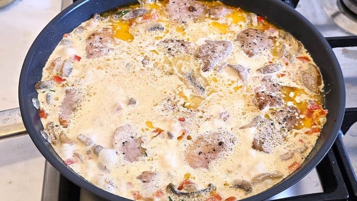 Simmering Fried Tenderloin Slices in the Creamy Sauce in the Pan