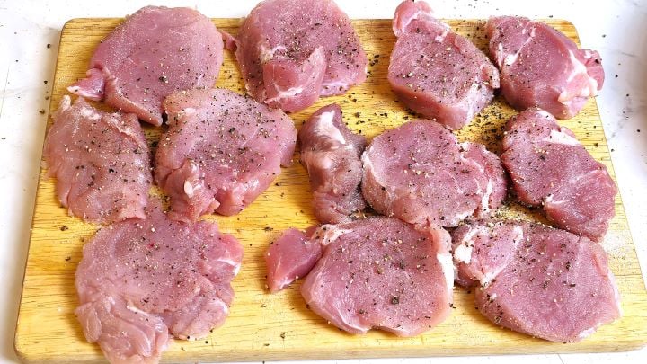 Sliced and Seasoned Pork Tenderloin on the Chopping Board