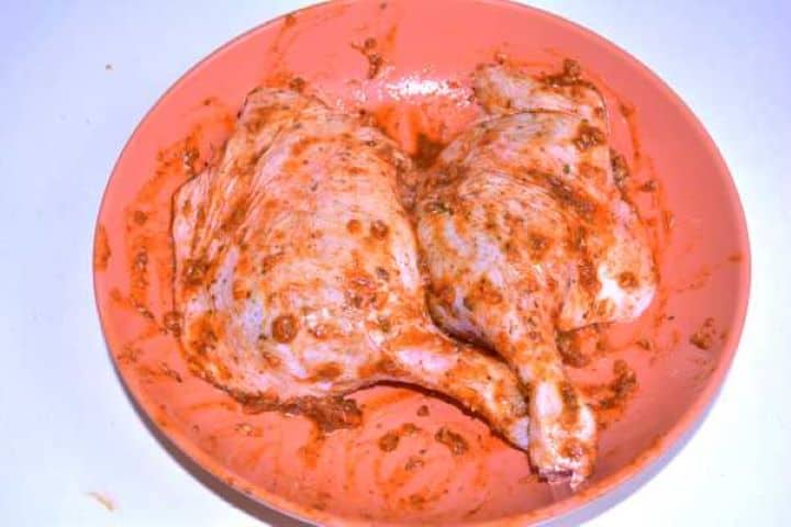Seasoning Massaging garlic marjoram and paprika seasoning paste onto pricked duck legs before marinating.