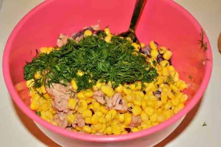 Ingredients in the Bowl Chopped fresh dill sprinkled over tuna corn salad with fresh lemon juice sea salt and black pepper.