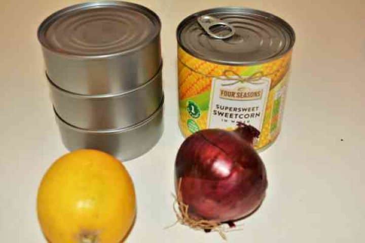 Ingredients Ingredients for tuna corn salad including canned tuna in sunflower oil sweetcorn red onion lemon and fresh dill.