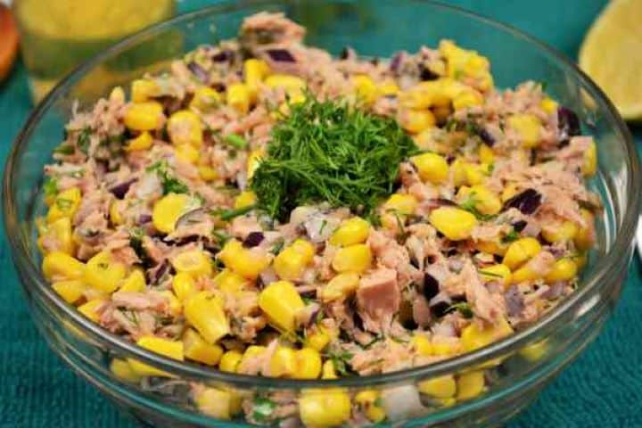 Serve Close up of fresh tuna corn salad served with a fork showing tender tuna chunks and golden sweetcorn.