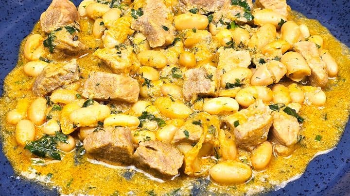 Pork and White Bean Stew Served on Blue Plate