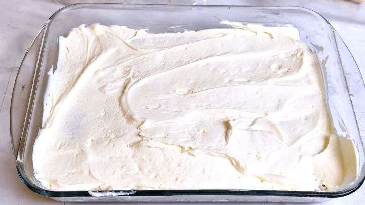 Mascarpone Cream Over the First Layer of Ladyfingers in the Glass Tray