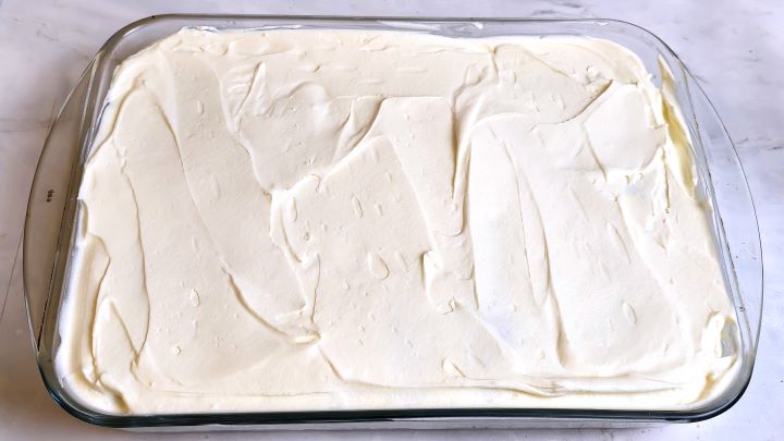 Mascarpone Cream Over the Second Layer of Ladyfingers in the Glass Tray