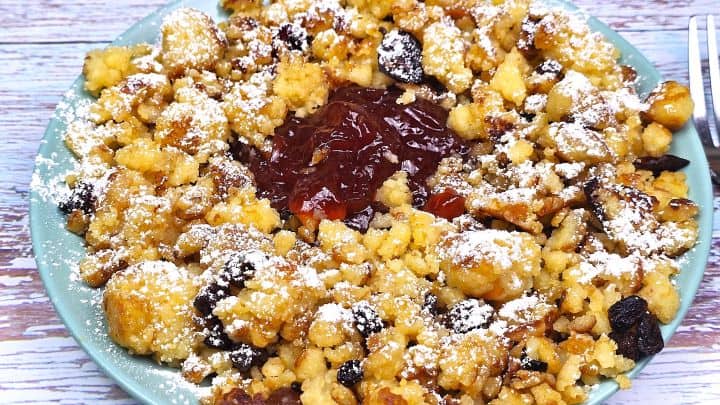 Hungarian Csaszarmorzsa (Shredded Pancake) Served on Plate With Raspberry Jam and Sugar on Top