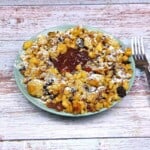 Hungarian Csaszarmorzsa (Shredded Pancake) Served on Plate With Raspberry Jam