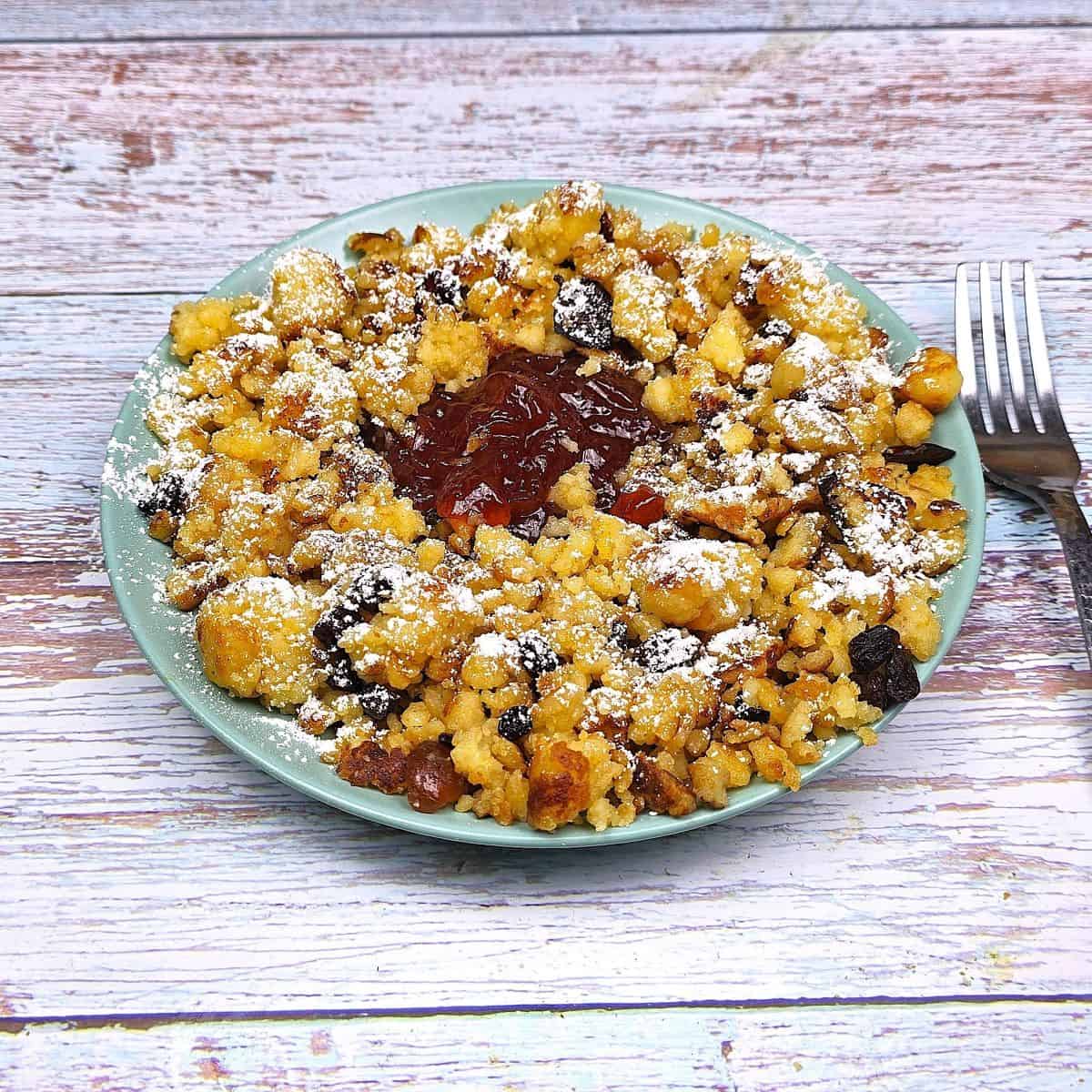 Hungarian Csaszarmorzsa (Shredded Pancake) Served on Plate With Raspberry Jam