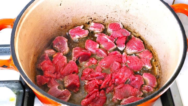 Diced lean beef chunks added to the hot Dutch oven to sear in olive oil.